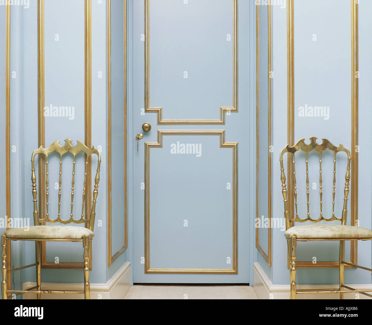 Two gold chairs in an empty room Stock Photo