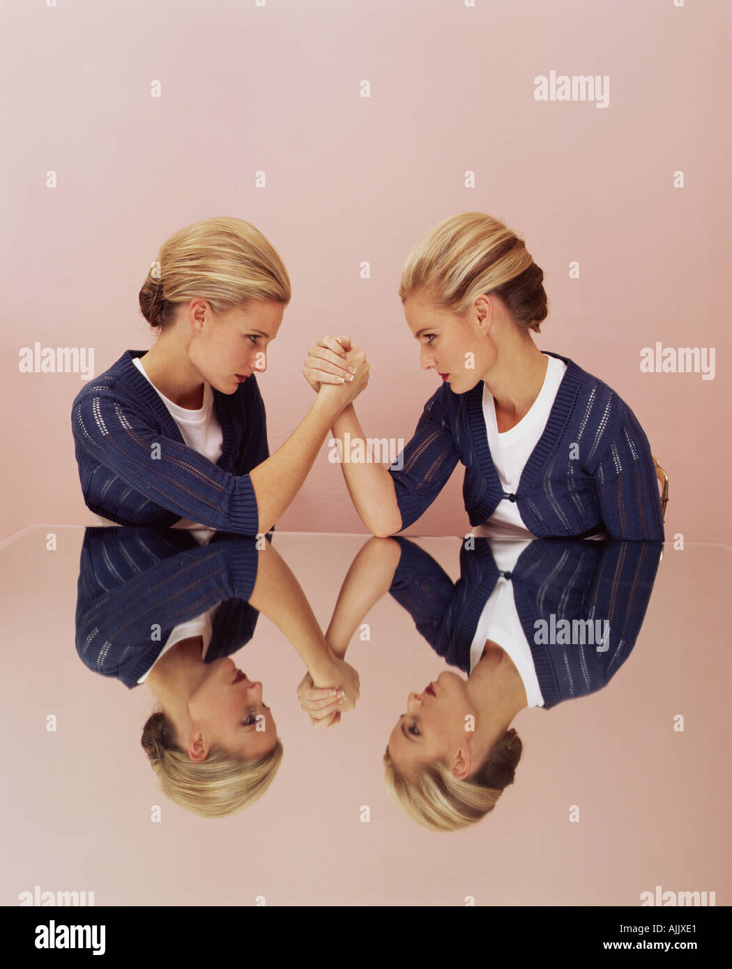 Two women arm wrestling Stock Photo