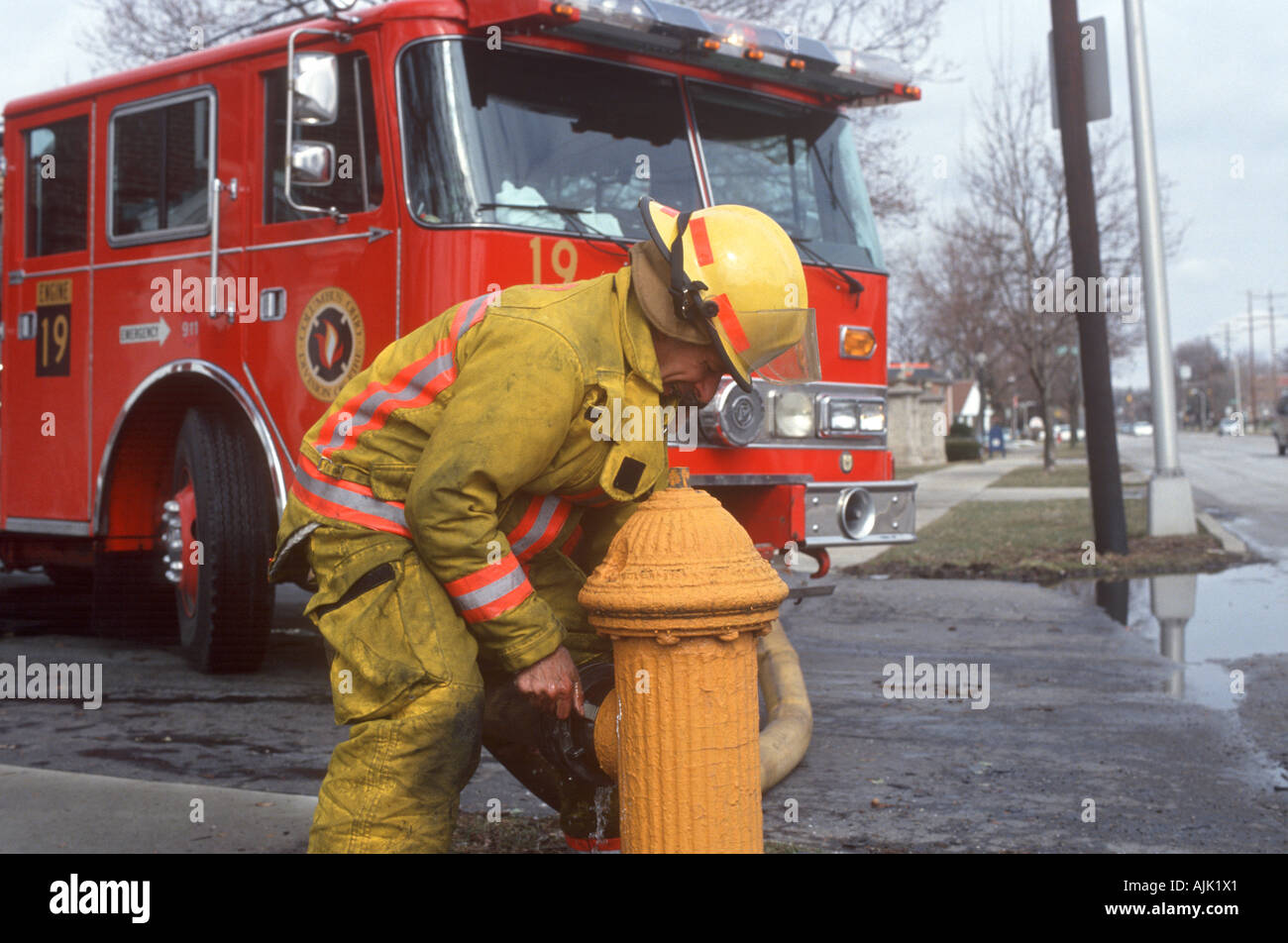 Firefighter in Columbus Ohio opens fire hydrant Stock Photo