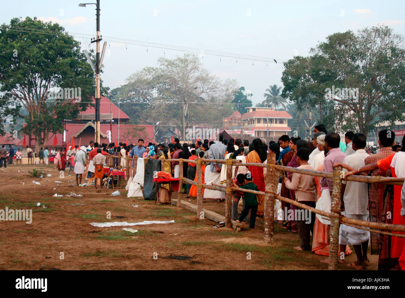 People standing in a queue to enter the temple of Lord Shiva in Aluva, Kerala Stock Photo