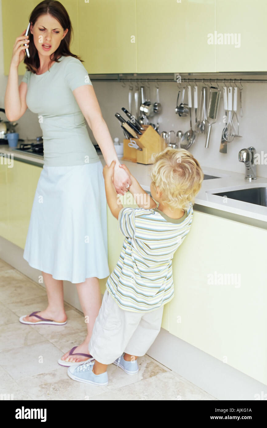 Boy pulling on mother's arm Stock Photo Alamy