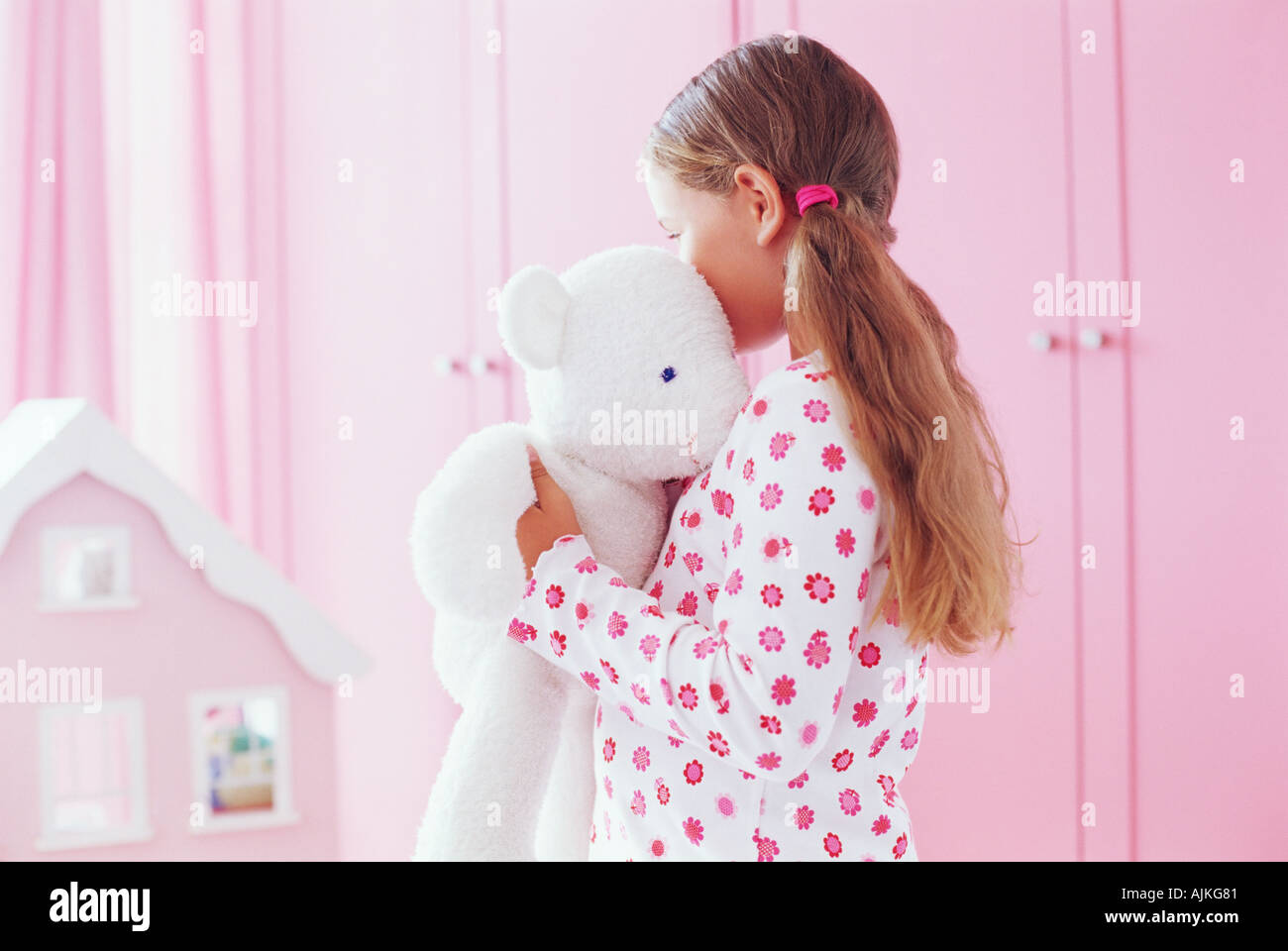 Girl hugging her teddy bear Stock Photo - Alamy