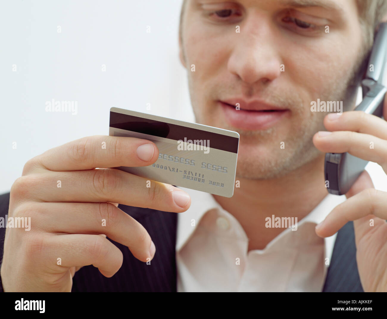 Man on mobile with credit card Stock Photo