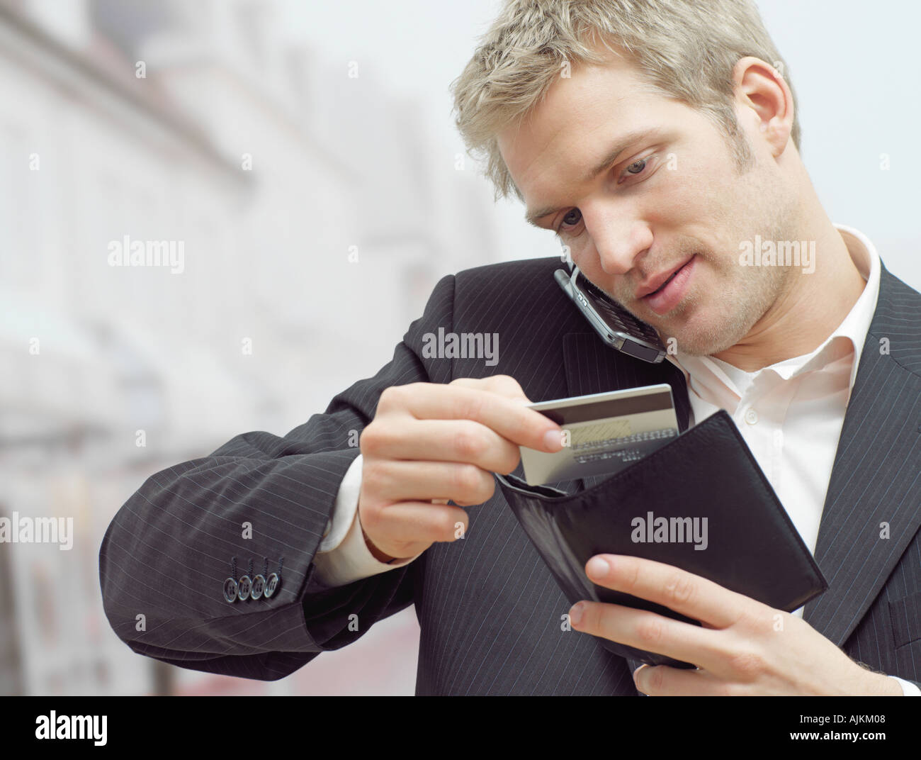 Man on mobile with credit card Stock Photo