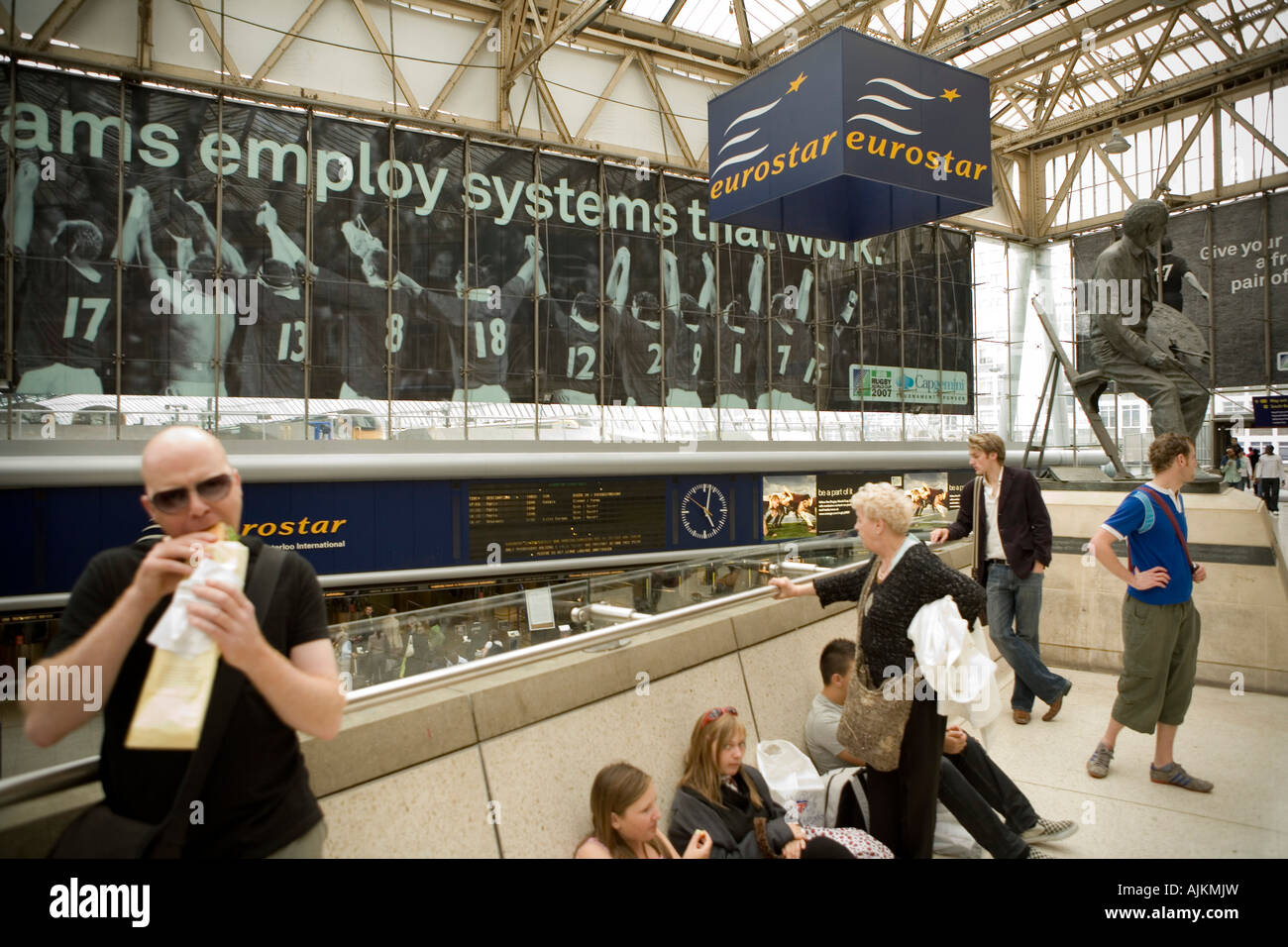 Passengers wait by the Eurostar terminal in Waterloo train station, London. Stock Photo