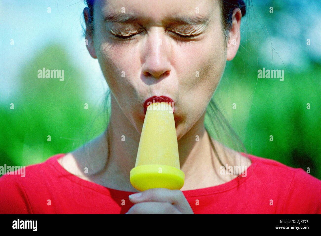 Woman eating an ice lolly Stock Photo