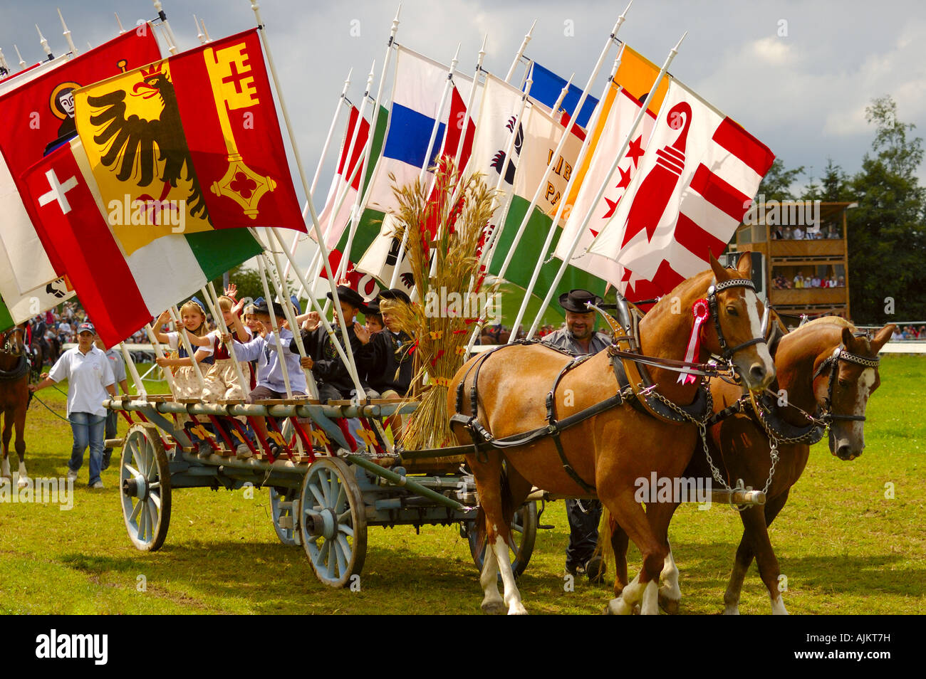 A horse drawn wagon bearing flags of the Swiss cantons at the Saignelegier horse fair Stock Photo