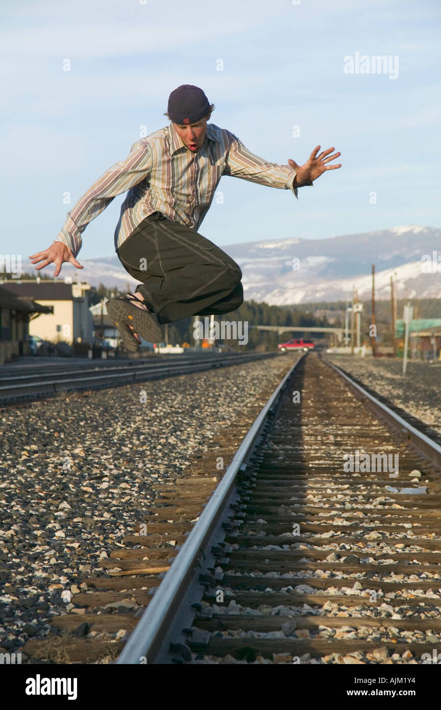 A man jumping over railroad tracks Stock Photo Alamy