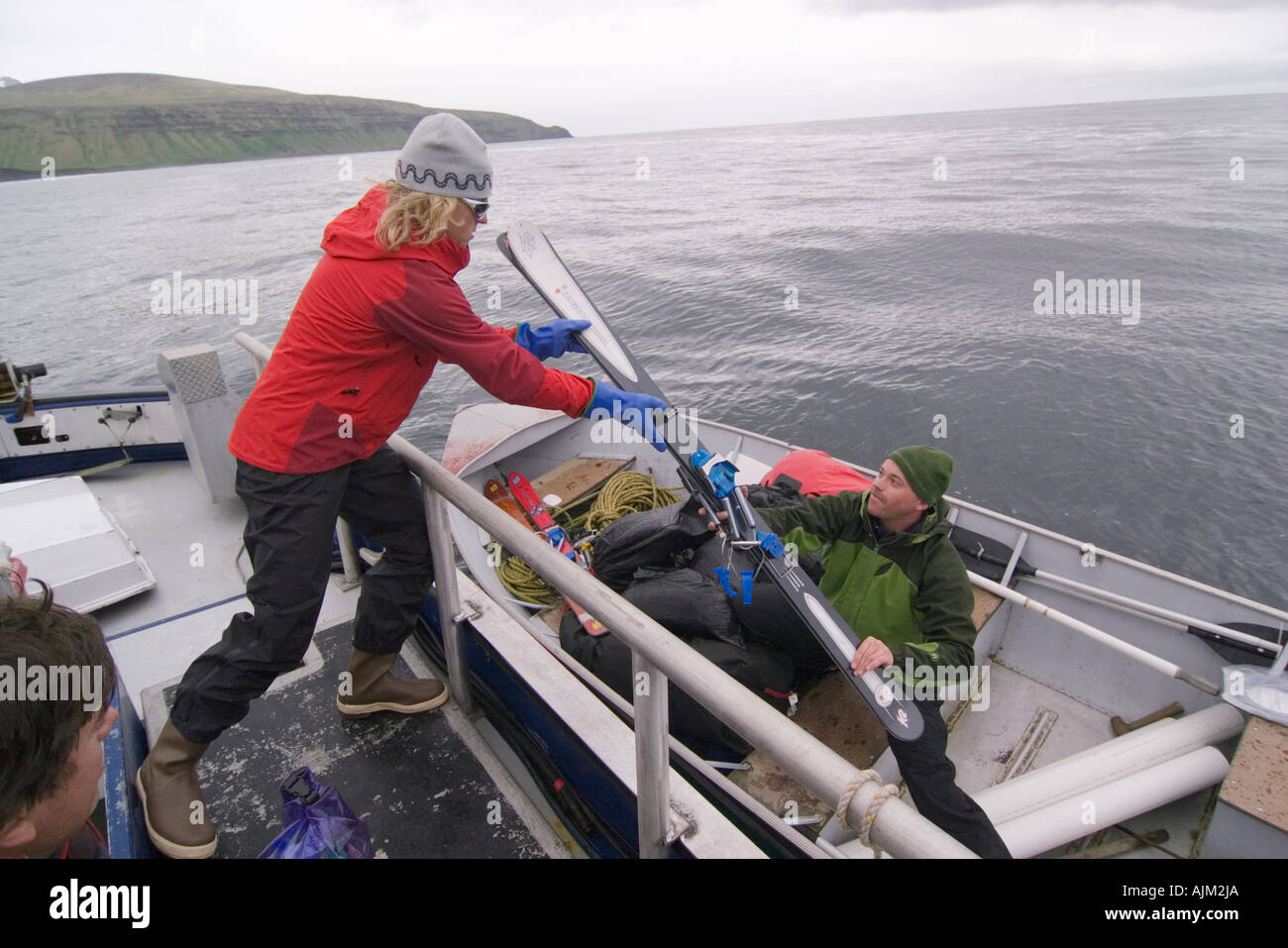 Loading ski equipment into a skiff in the Aleutian Islands in Alaska