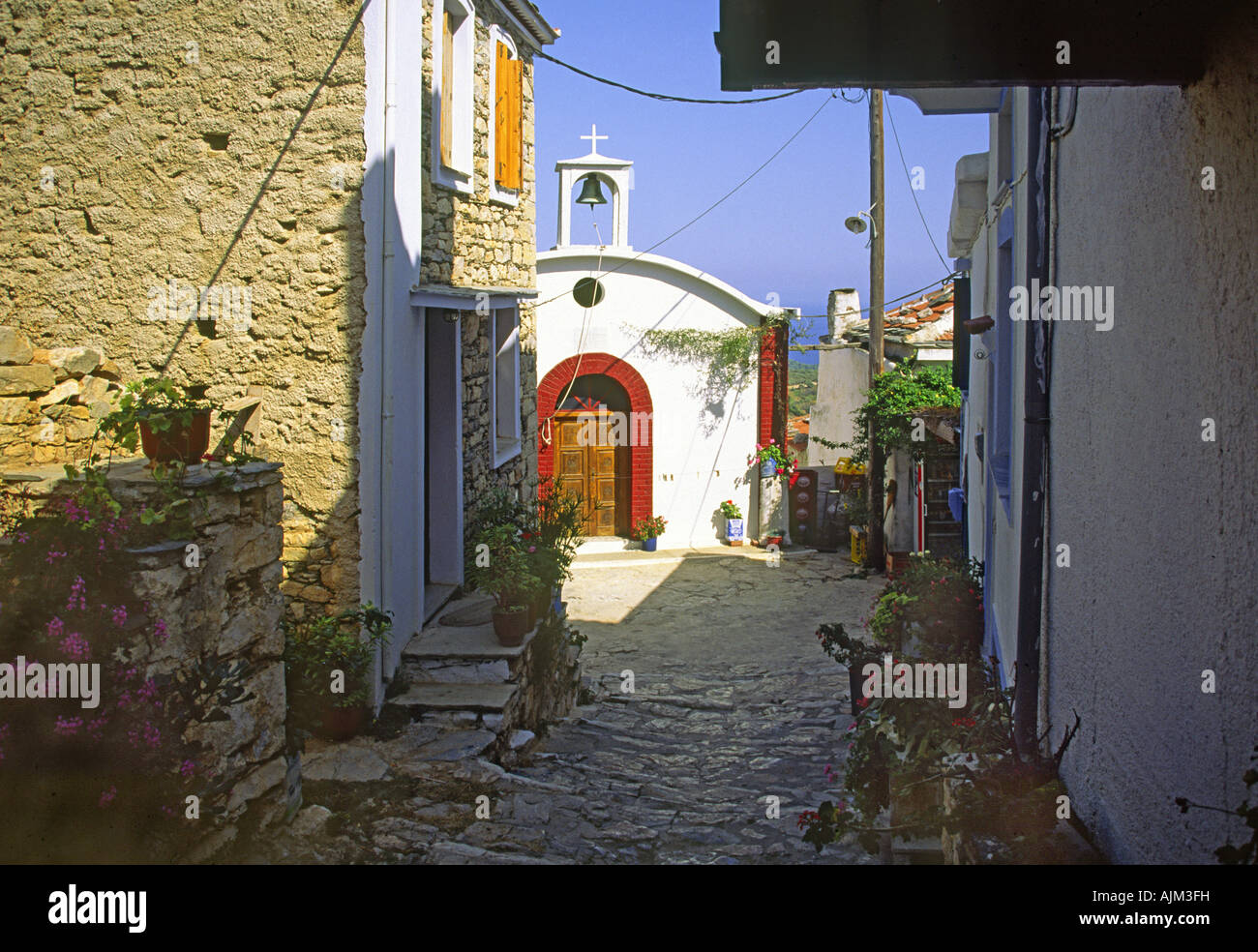 Backstreet with Church in Old Allonissos Town. Stock Photo