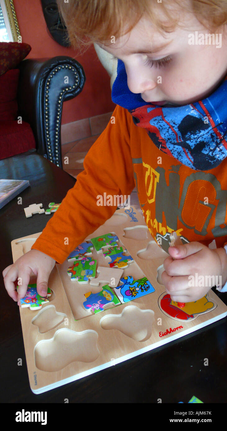 little child doing a jigsaw Stock Photo Alamy