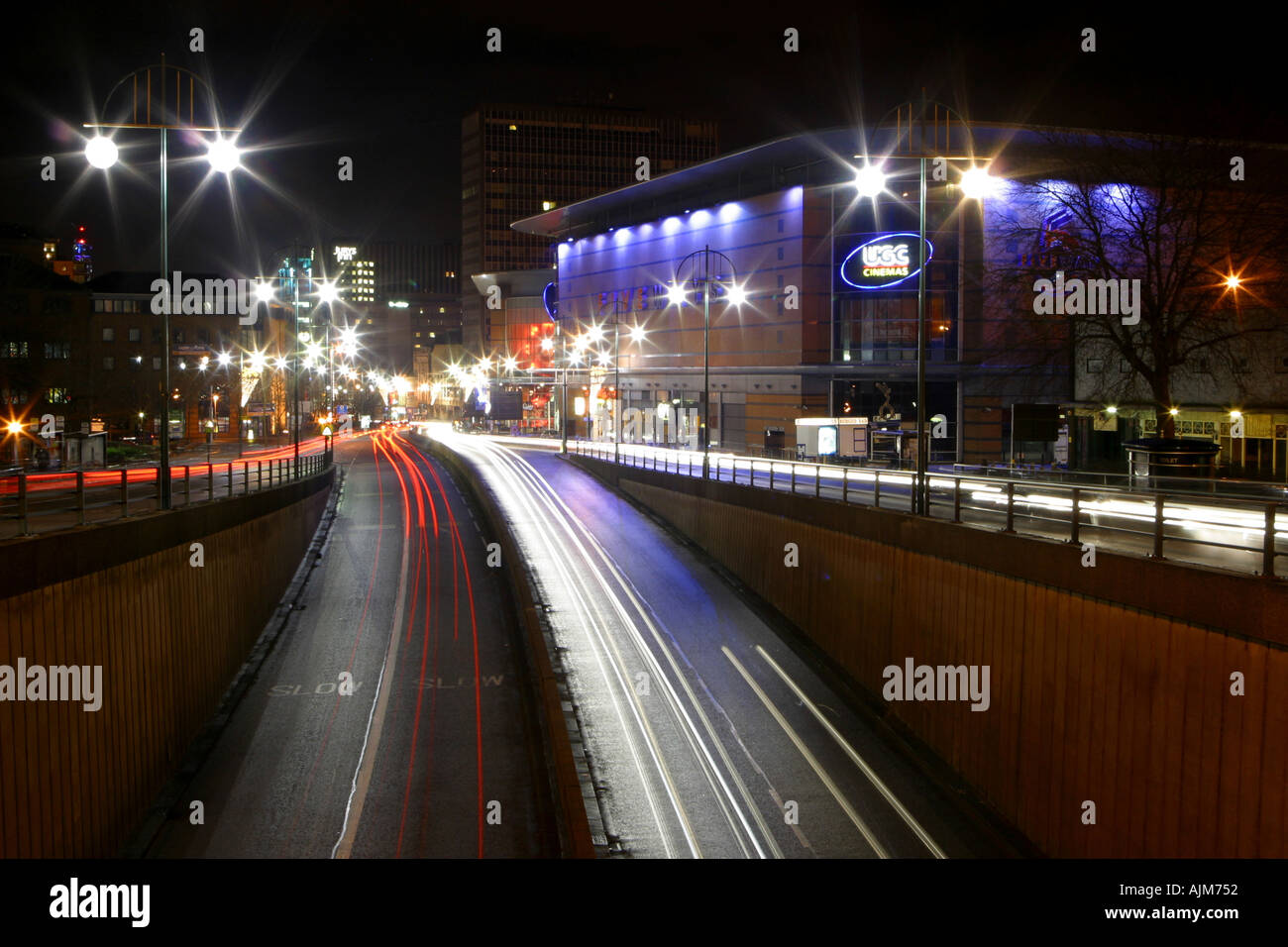 Traffic on a busy street showing traffic trails from the car lights at night Location is Broad