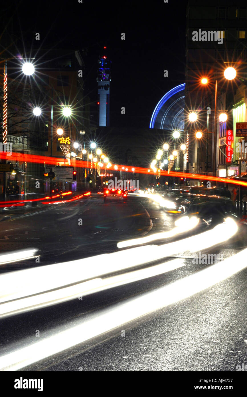 Traffic on a busy street showing traffic trails from the car lights at night Location is Broad