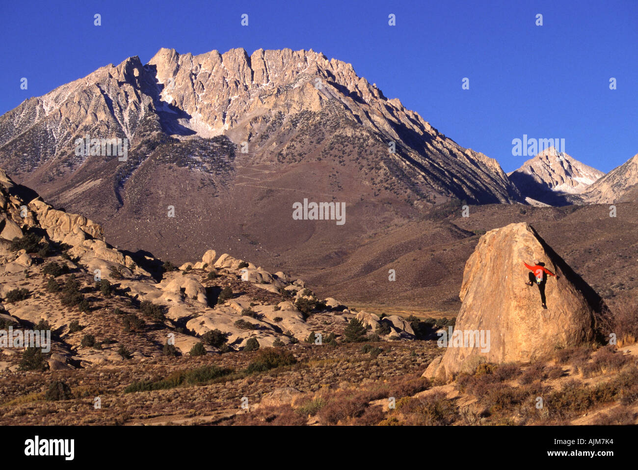 A man rock climbing at The Buttermilks CA Stock Photo