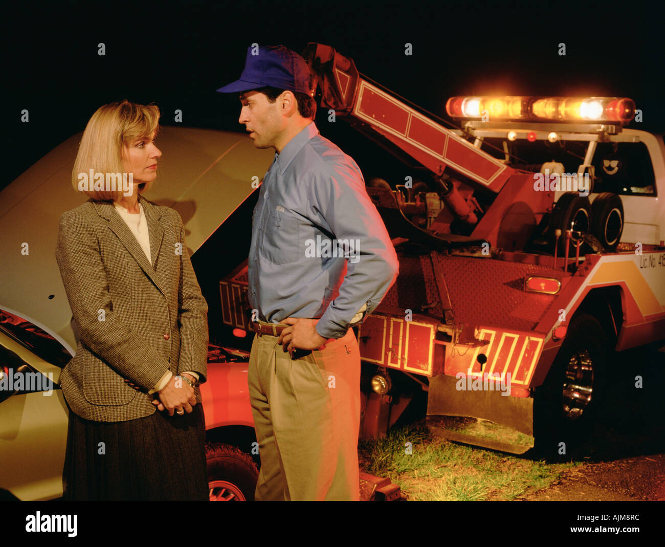 Woman having her car towed Stock Photo - Alamy