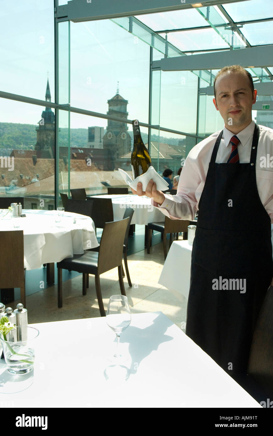 Waiter with Riesling wine in Restaurant Cube and Stiftskirche church at the back STUTTGART Germany Year 2007 Stock Photo
