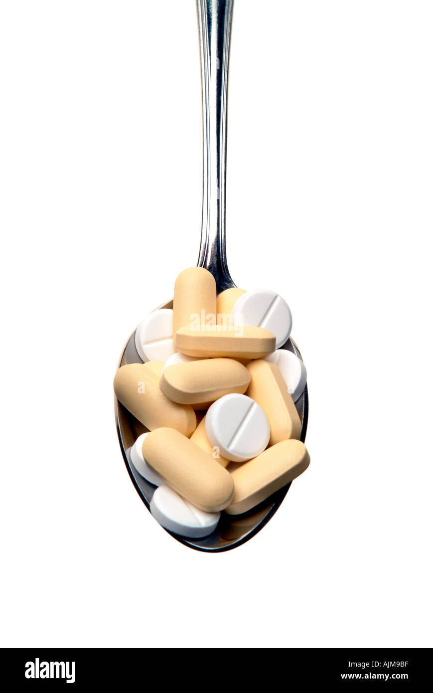 Spoon full of tablets Stock Photo