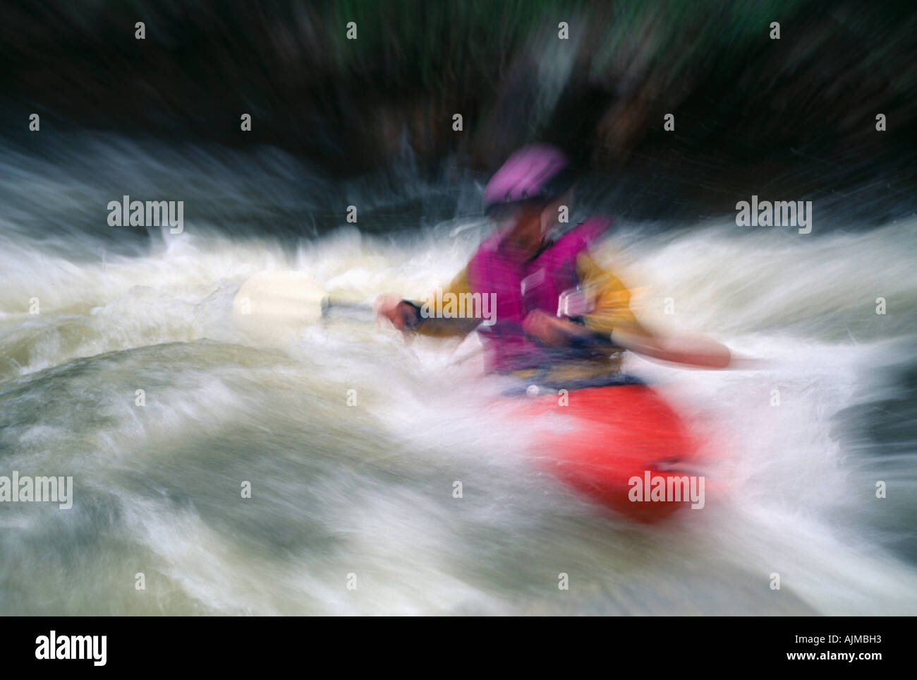 Kayaker paddling in spring runoff abstract Rocky Mtns CO Stock Photo