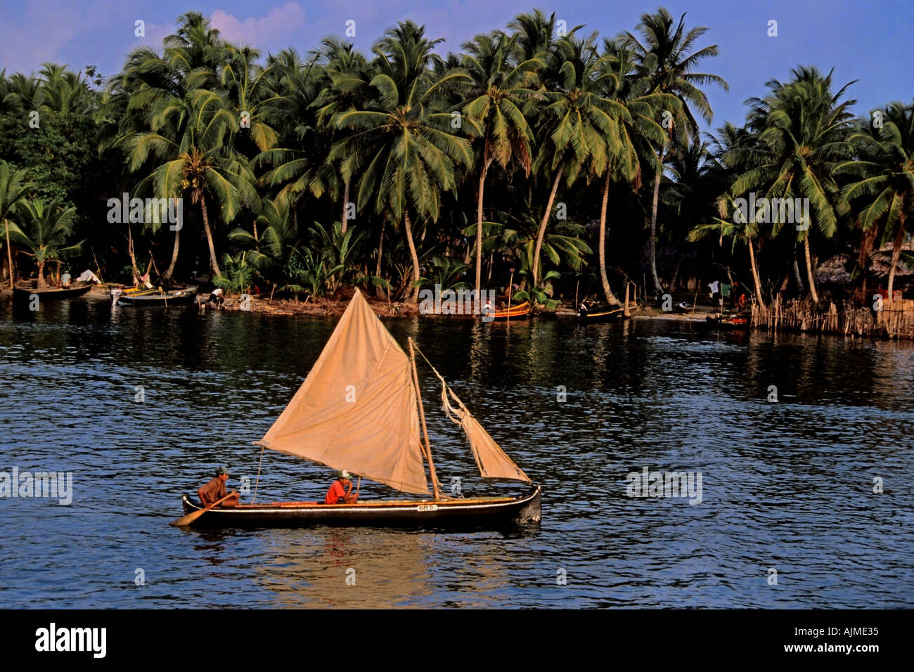 Kuna Indians sailing dugout canoe into their village at sunset San Blas Islands Panama Central America Stock Photo