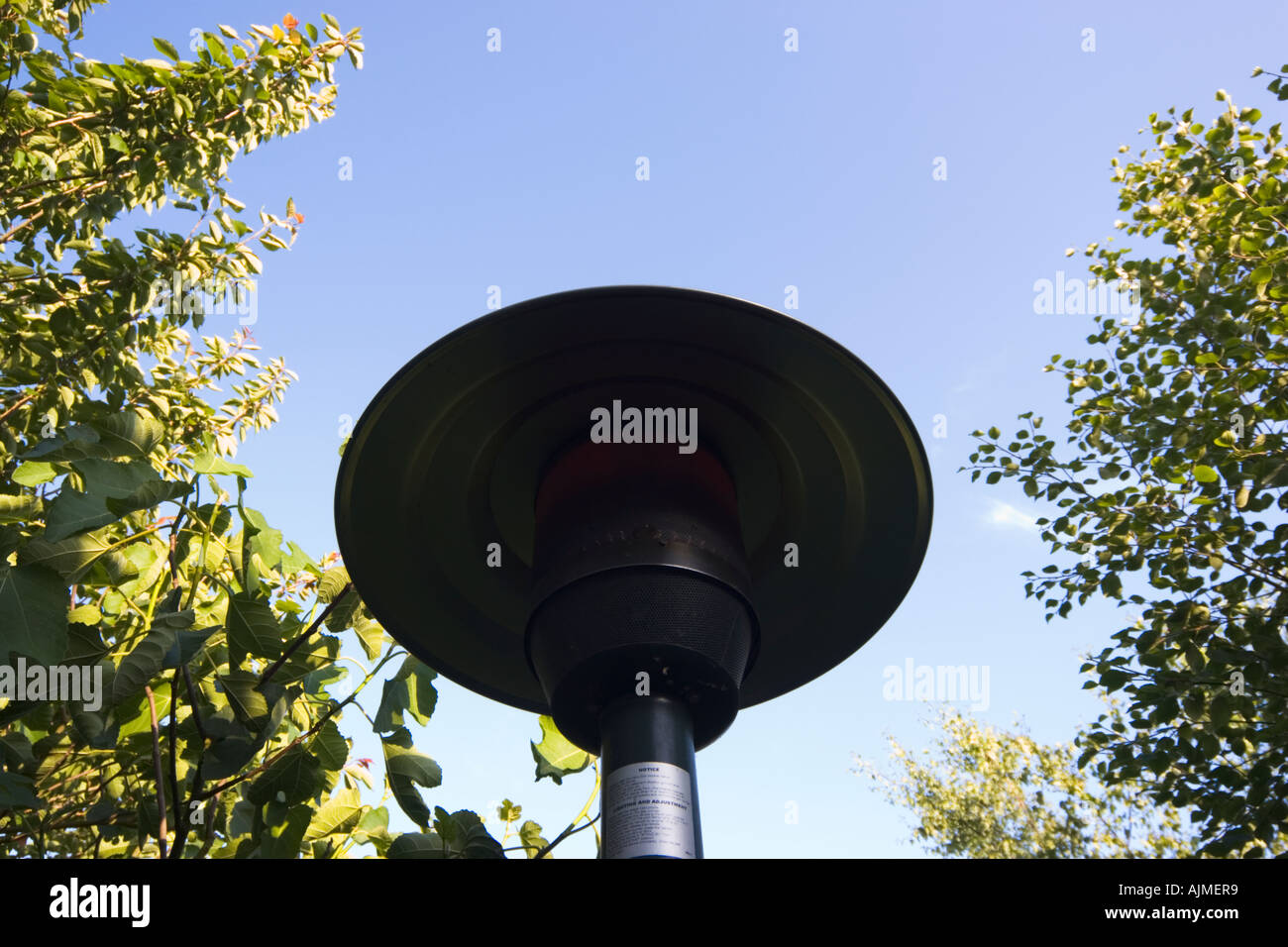 Garden patio heater glowing red calor bottled gas burner Stock Photo