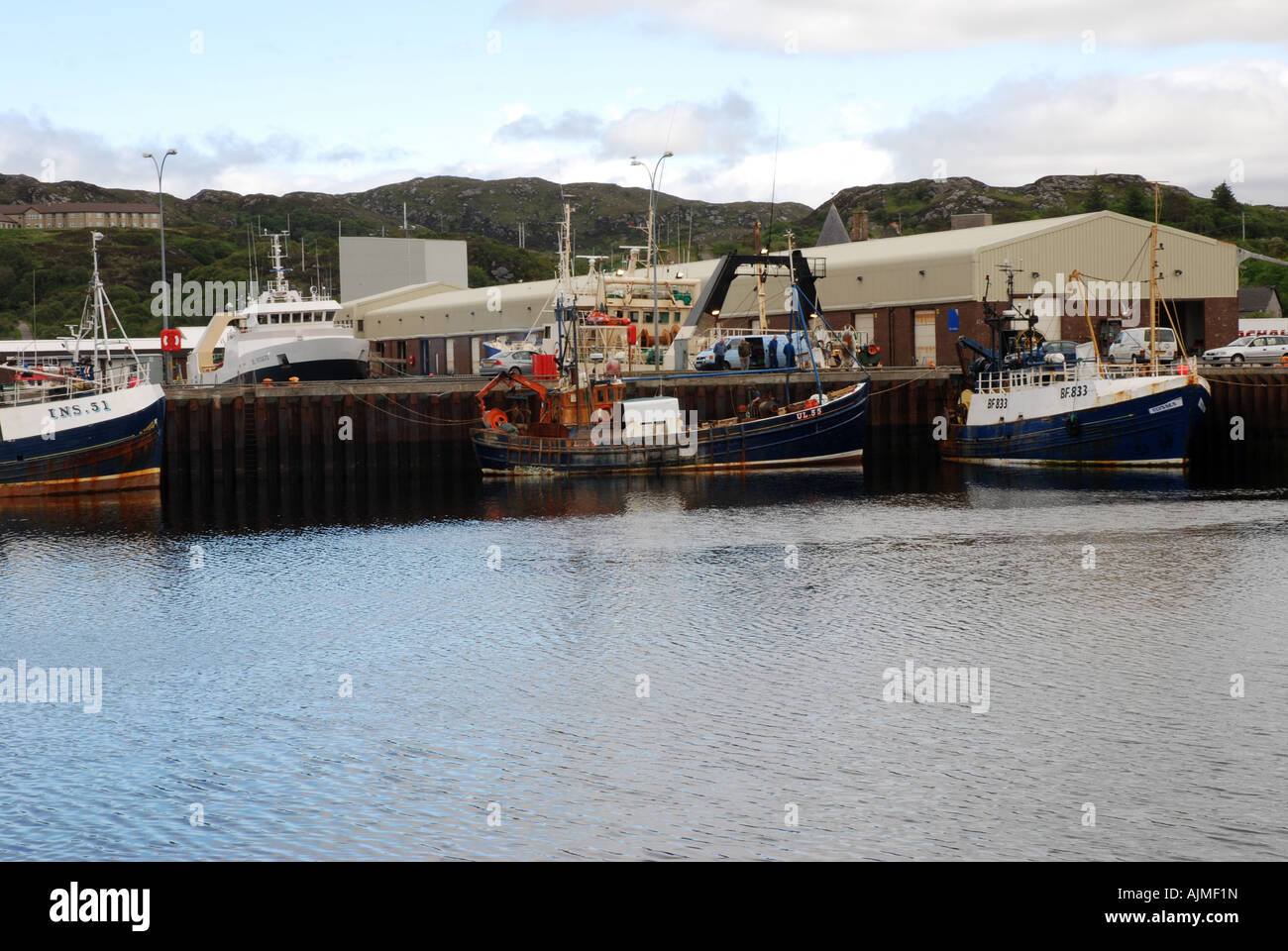 Fishing vessels docking at Fish Processing plant at Lochinver Atlantic coast Highland Scotland