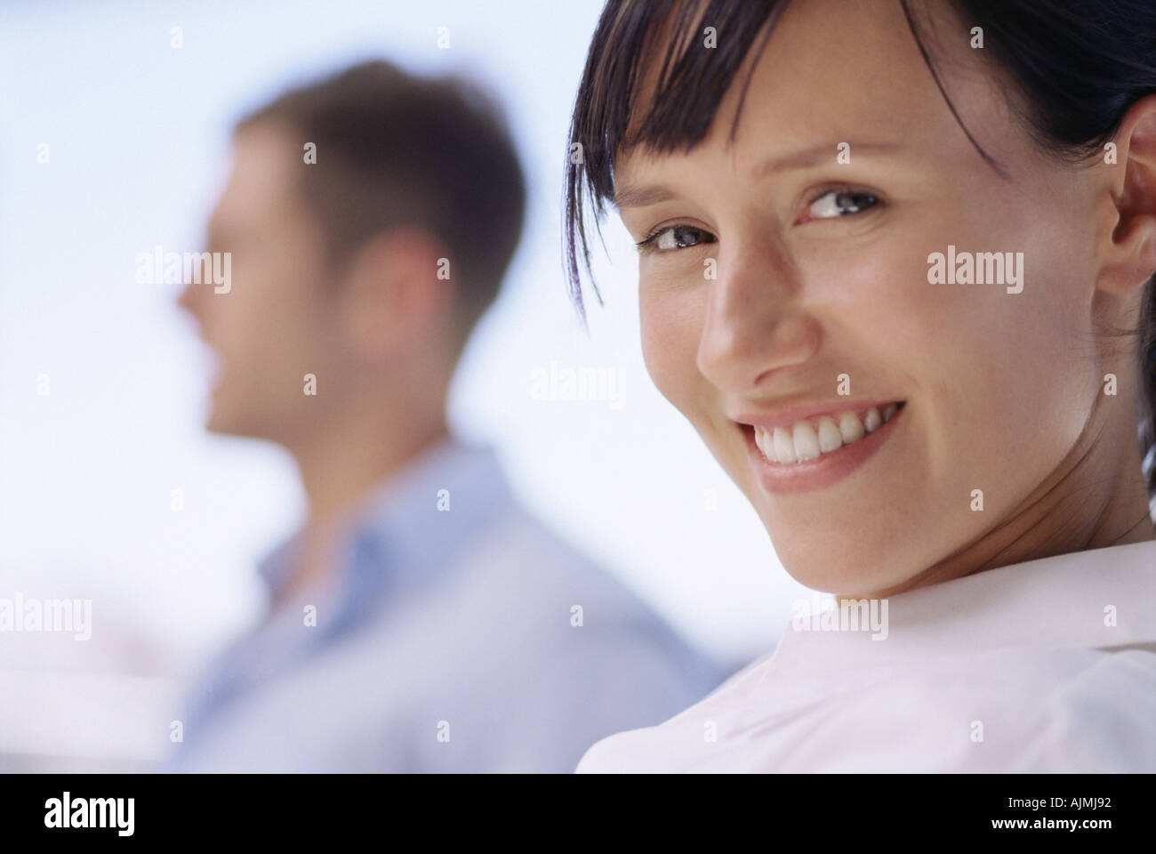 Smiling woman with colleague Stock Photo