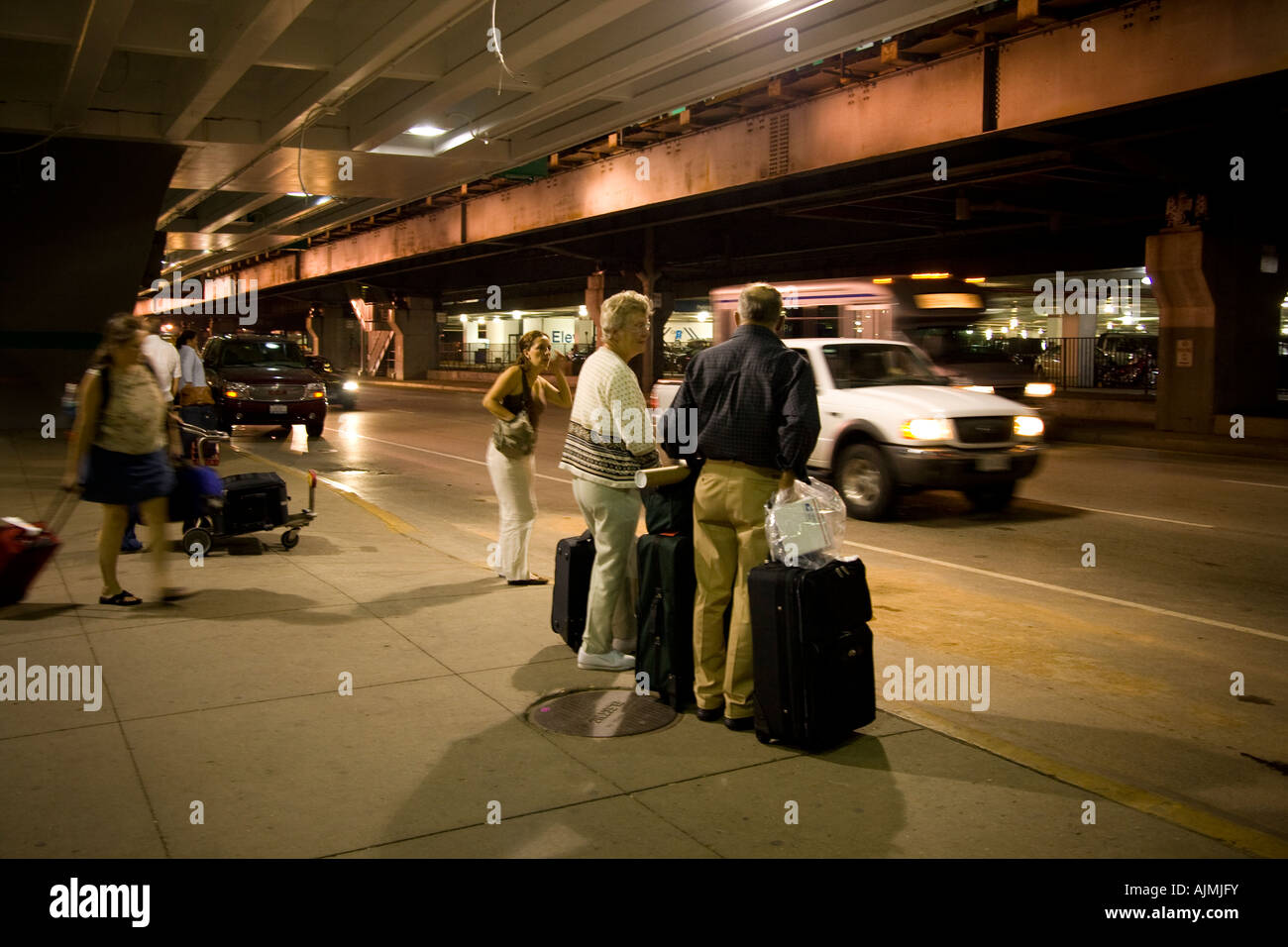 People at airport curbside pickup awaiting rides Chicago O'hare Stock