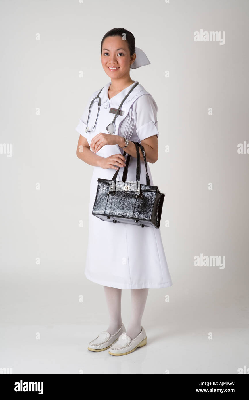 Standing nurse in white uniform Stock Photo Alamy