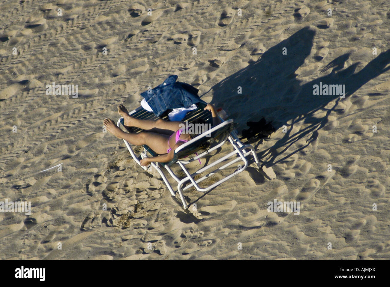 San Juan Puerto Rico Isla Verde beach, with woman sunbather on lounge chair, aerial view Stock Photo