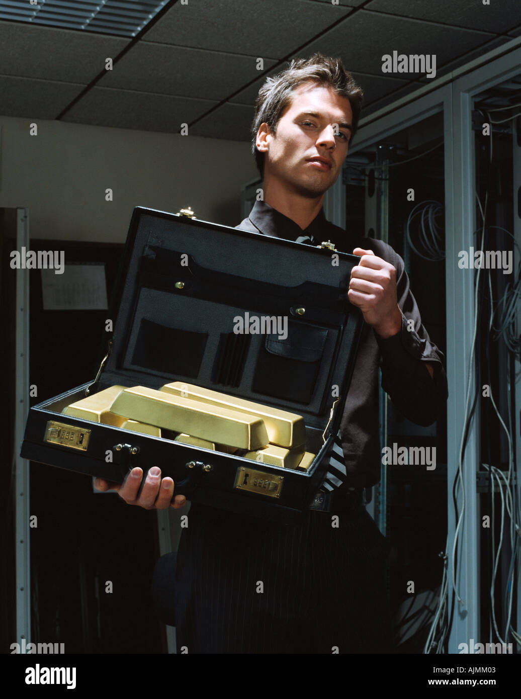 Man with a briefcase of gold bars Stock Photo Alamy