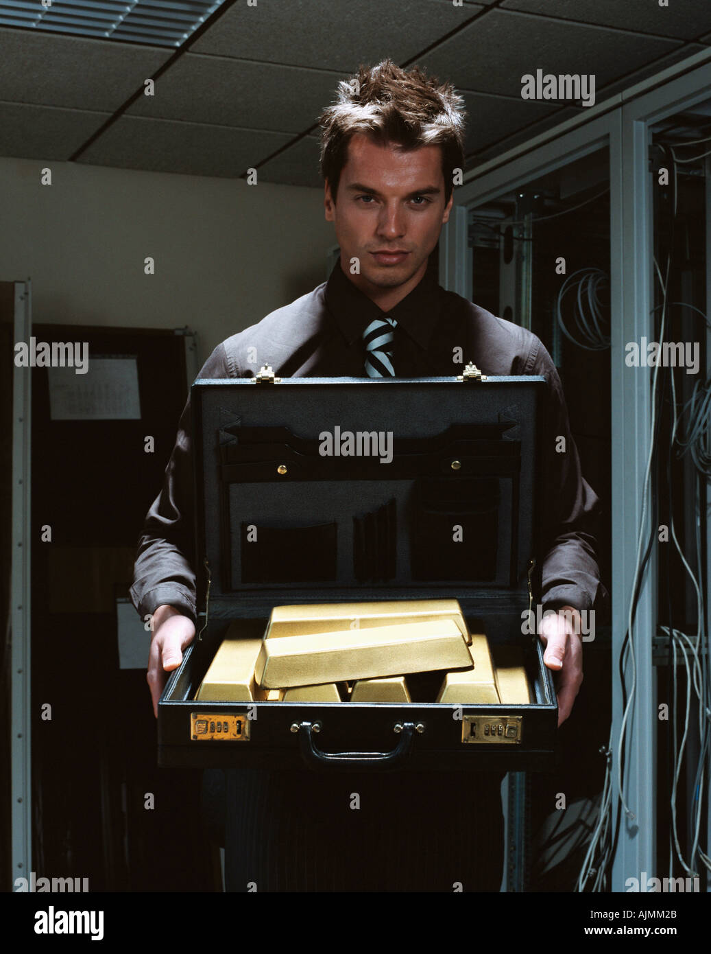 Man with briefcase of gold bars Stock Photo Alamy