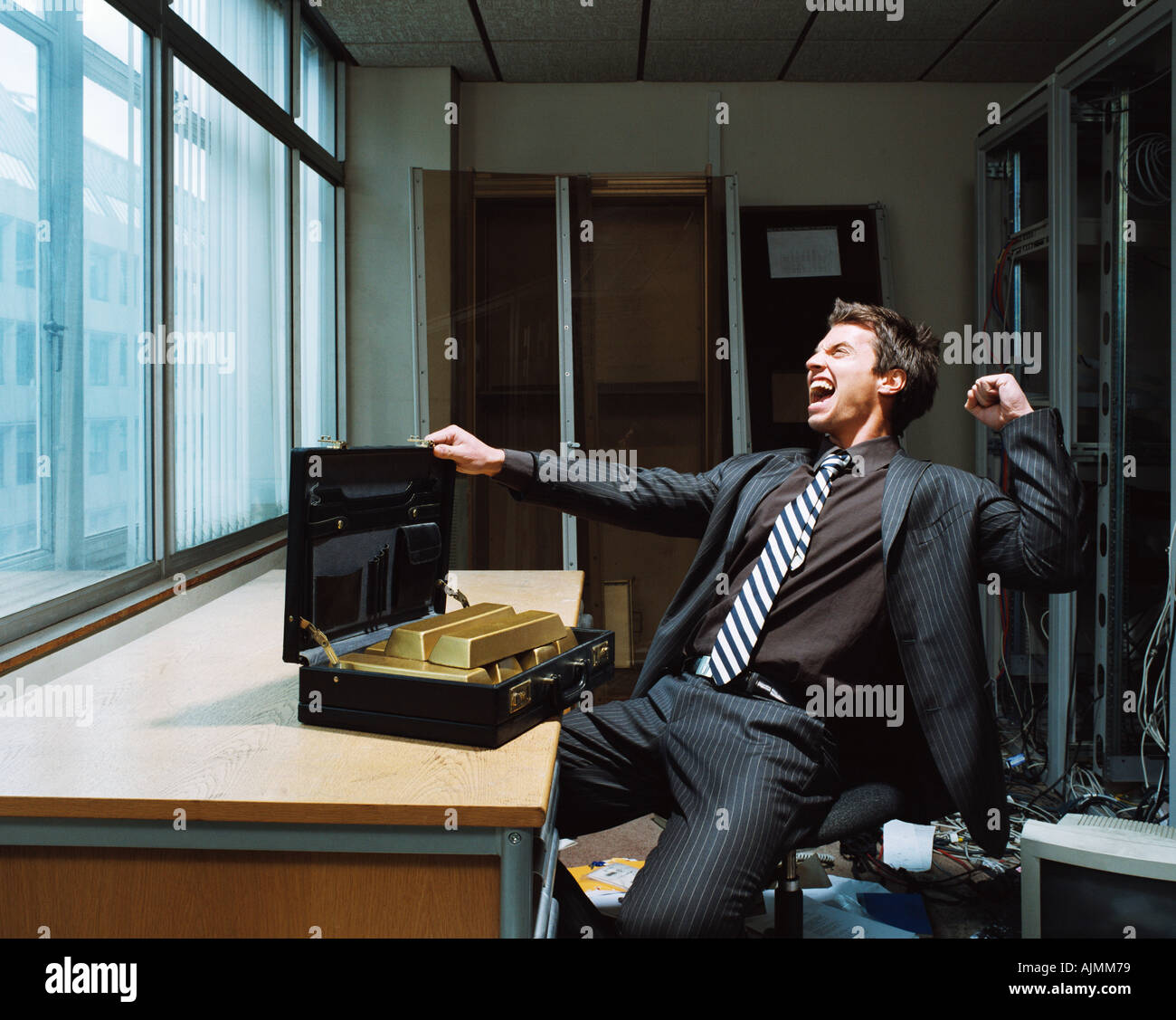 Businessman with briefcase of gold bars Stock Photo Alamy