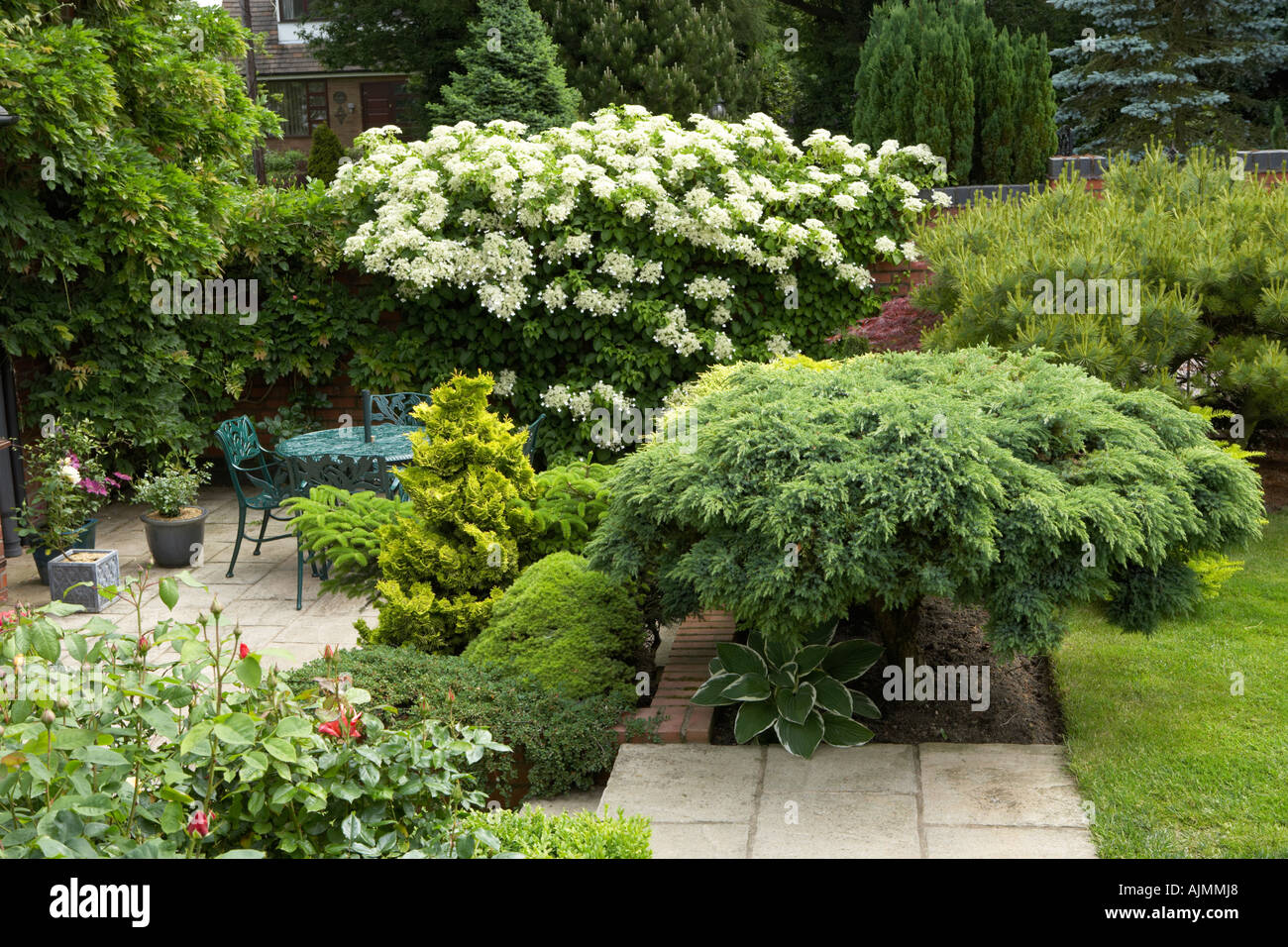 patio with established plants in the garden of Cypress House Dalton Stock Photo