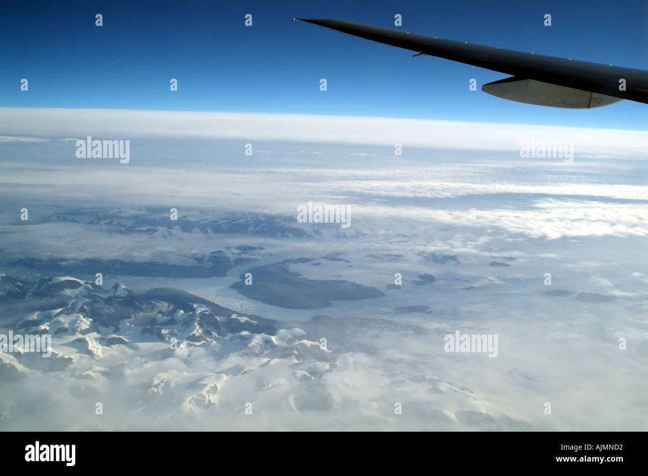 Southern Greenland landscape below wingtip of Boeing 777 aircraft Stock Photo