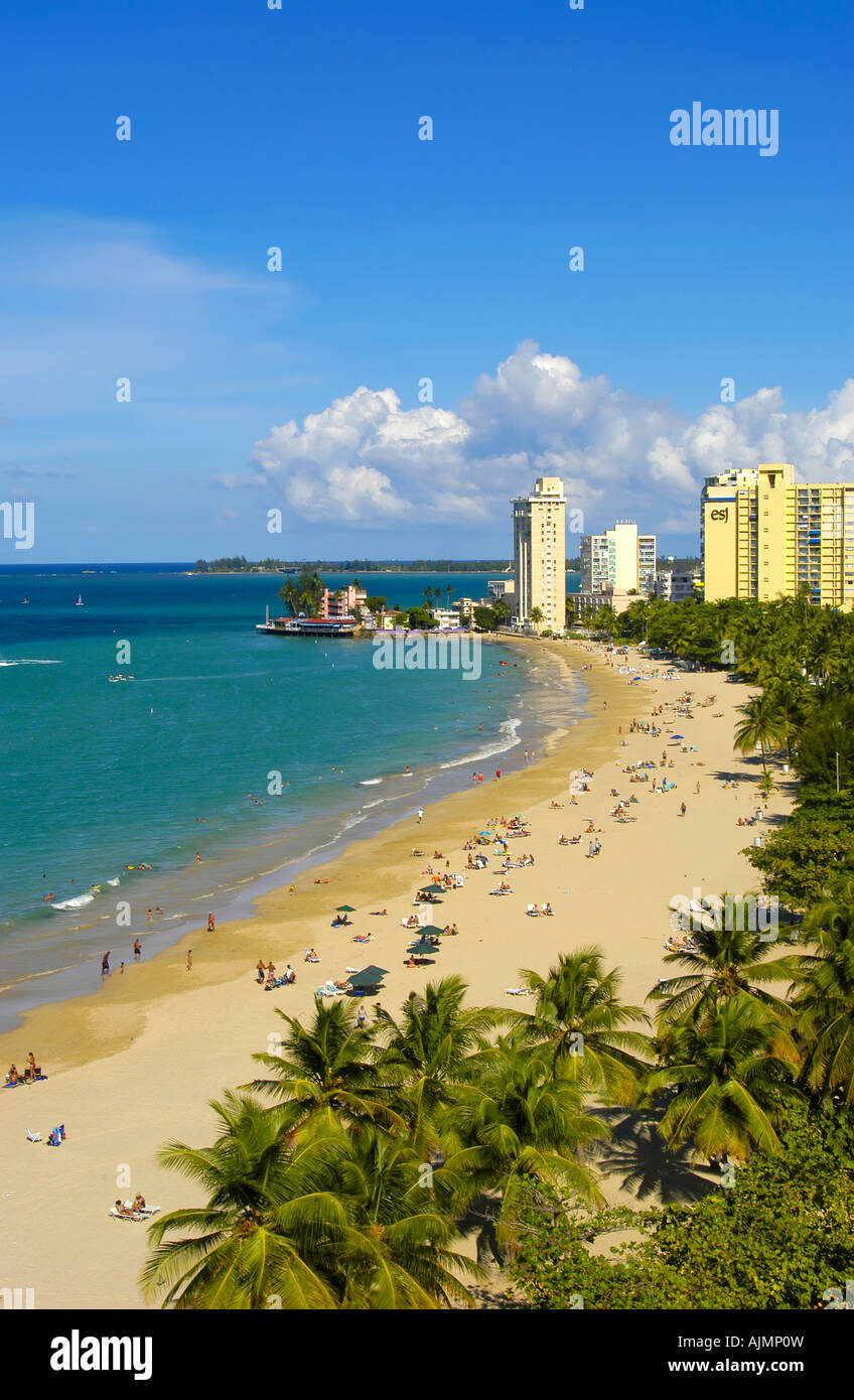 San Juan Puerto Rico Isla Verde Caribbean islands, famous beach with sunbathers, blue sky and resort hotels in background, plam Stock Photo