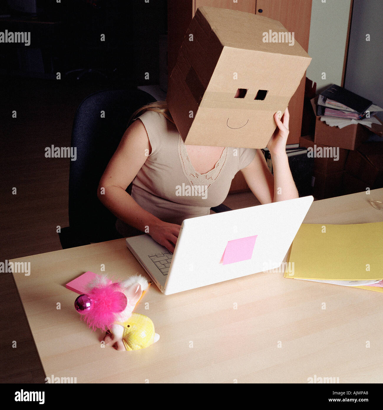 Woman wearing a cardboard box Stock Photo
