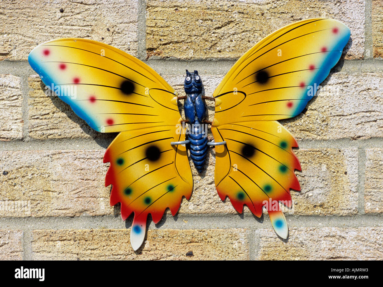 Metal garden ornament butterfly on a house wall Stock Photo Alamy