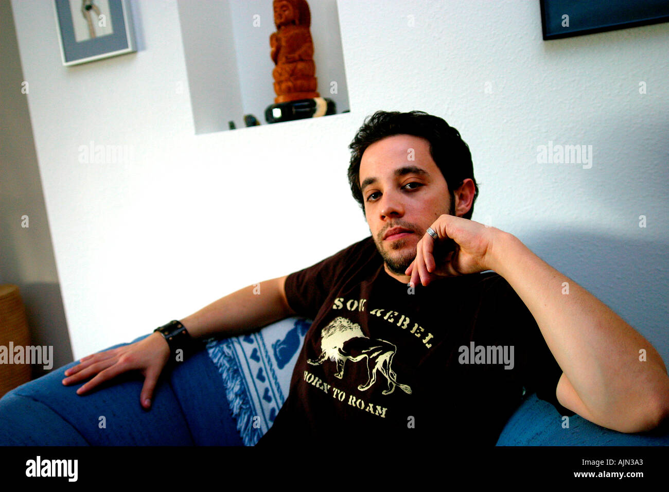 YOUNG MAN RELAXING AT HOME Stock Photo