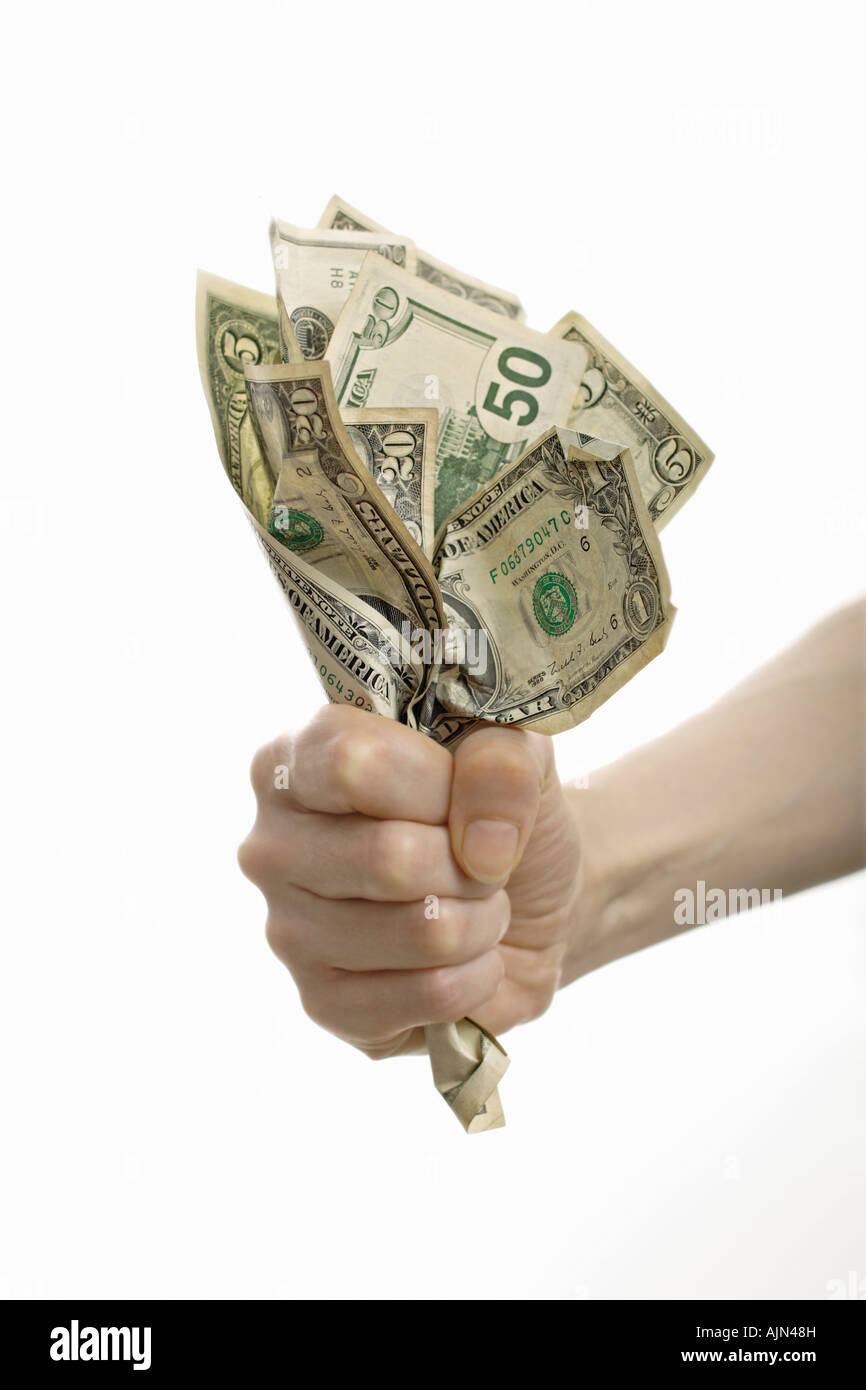 Fisted hand with crinkled dollar bills cut out Stock Photo