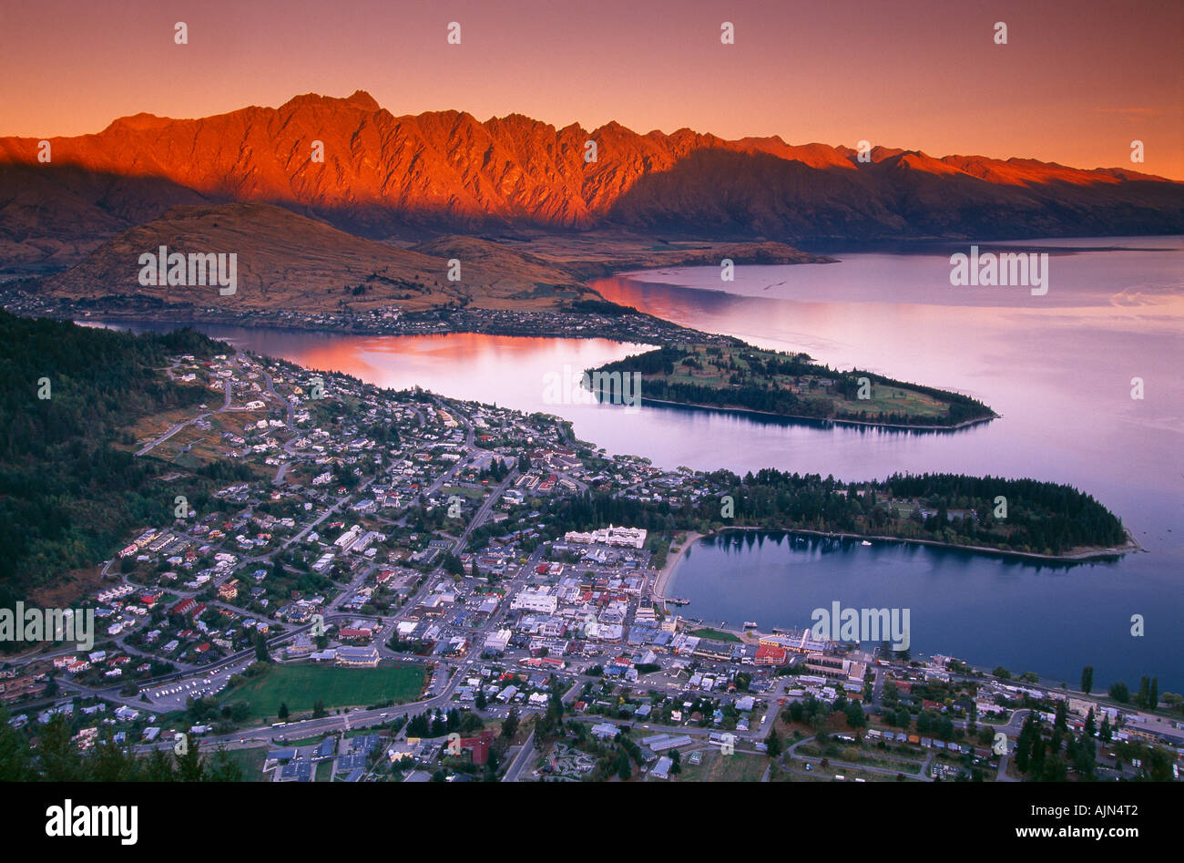 evening twilight on the Remarkables with Lake Wakatipu and Queenstown at dusk South Island New Zealand Stock Photo