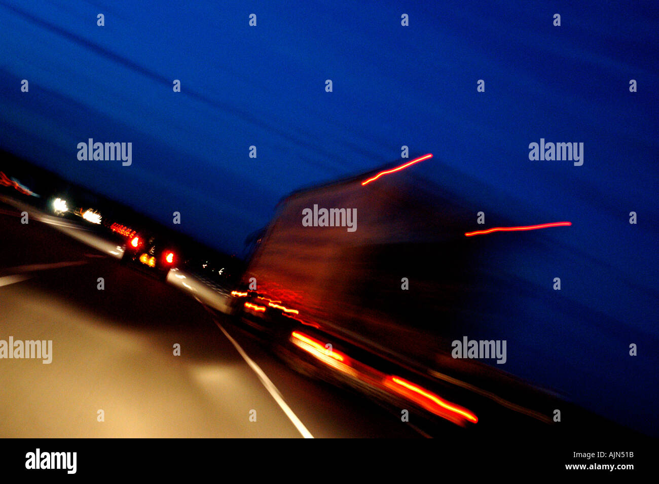 Delivery lorry speeds through the night as dusk arrives Stock Photo
