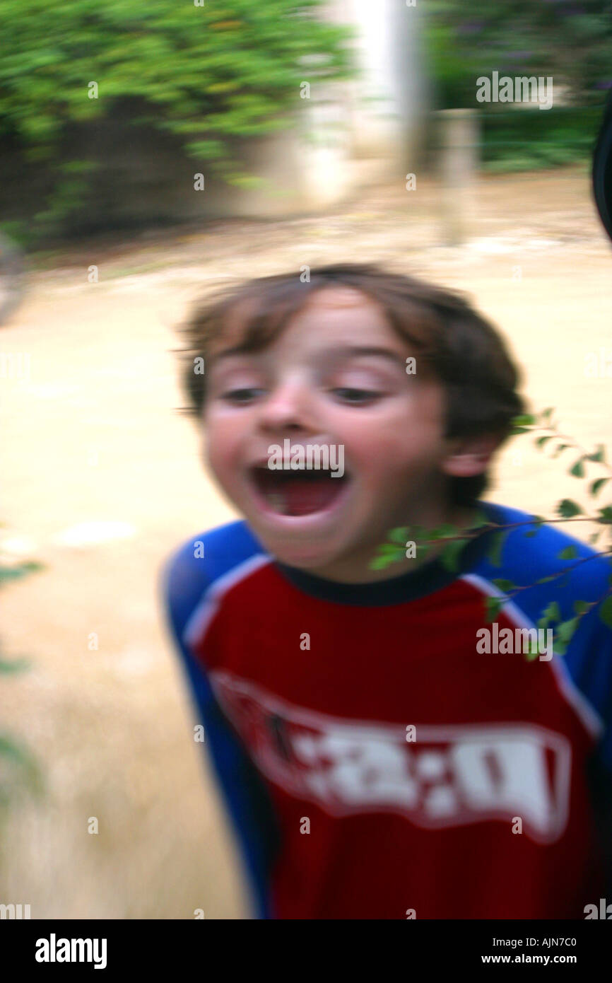 BOY GURNING IN DISTORTING MIRROR Stock Photo