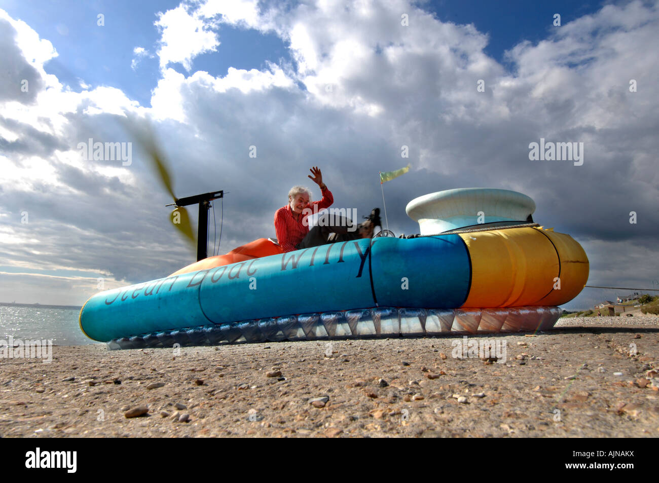 Scientist in his 70s drives his pedal powered hovercraft up a slipway on the River Solent near the worlds only Hovercraft Museum Stock Photo