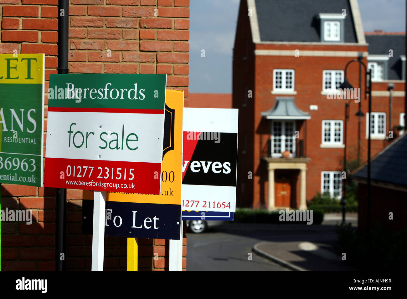 Estate Agents For Sale signs and boards outside houses in Essex Stock