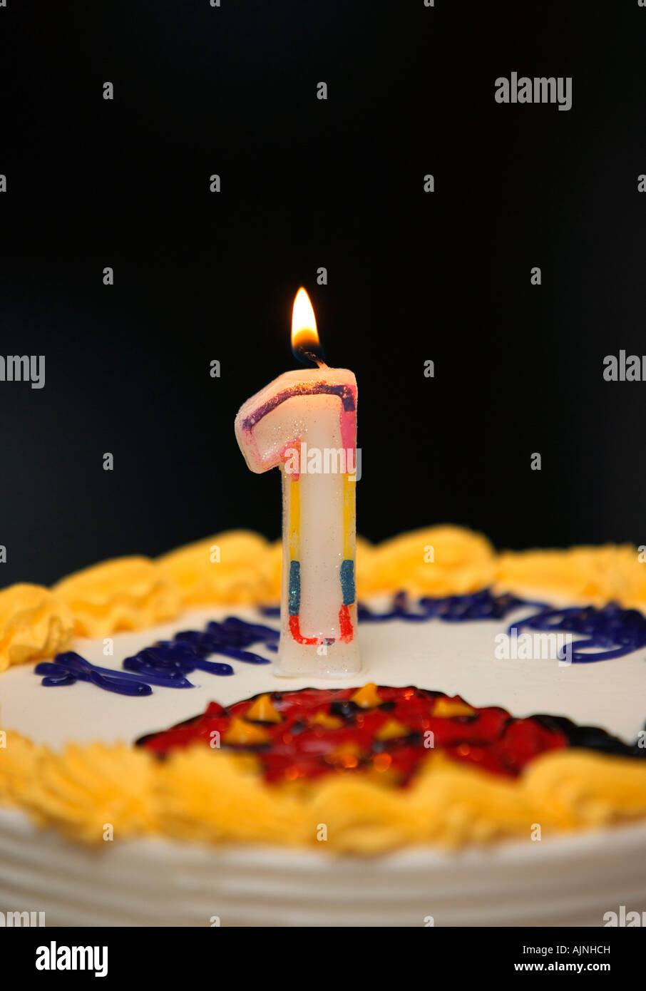 A birthday cake with lit candle Stock Photo Alamy