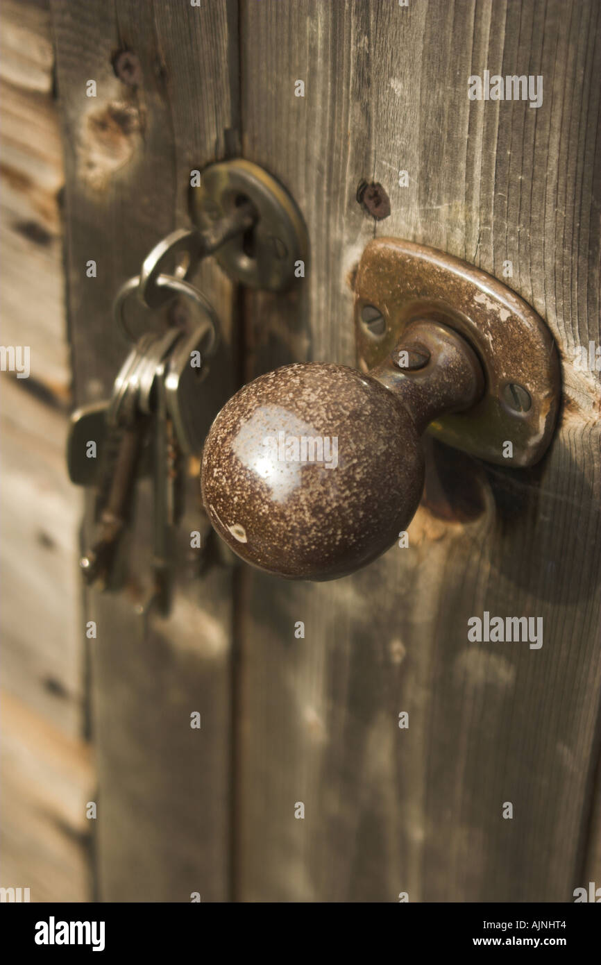 A Bunch Of Keys In The Lock Of A Door To A Garden Shed