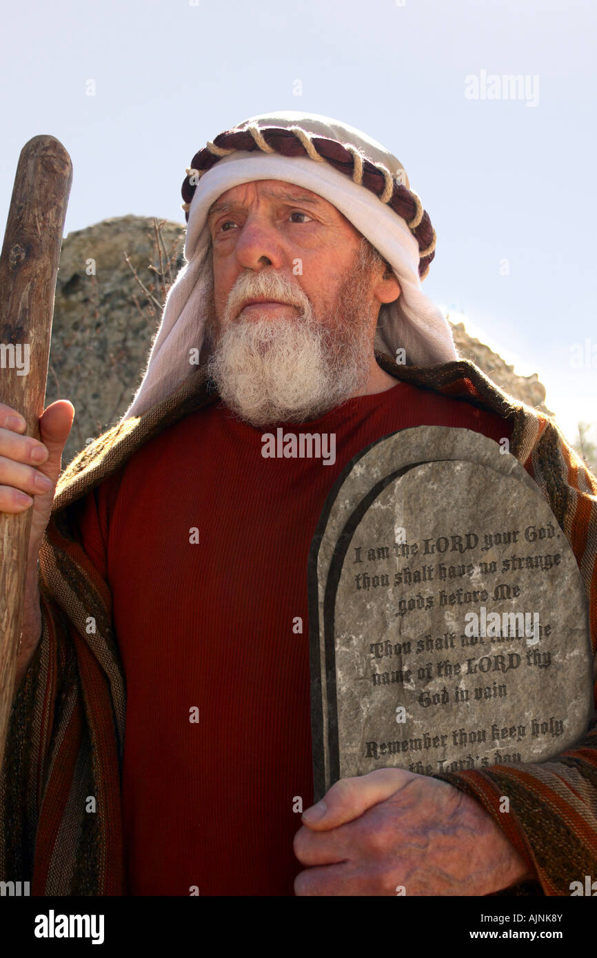 Front view of a senior man holding cane and the 10 commandments Stock Photo