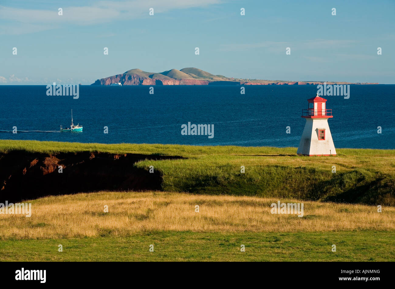 Lighthouse and fishing boat at Cap Alright, Magdalen Islands, Quebec, Canada Stock Photo Alamy