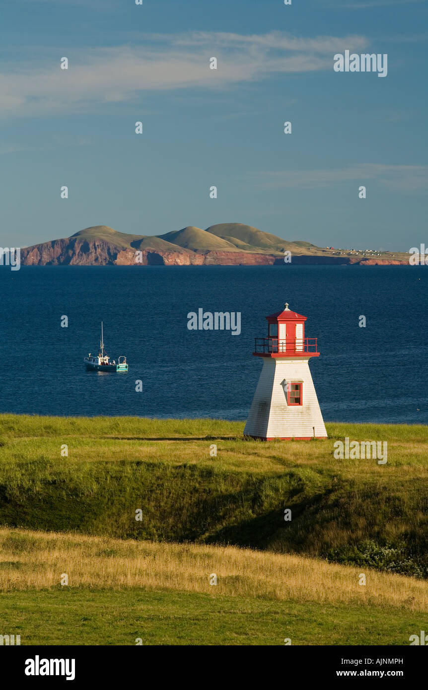 Lighthouse and fishing boat at Cap Alright, Magdalen Islands, Quebec, Canada Stock Photo Alamy