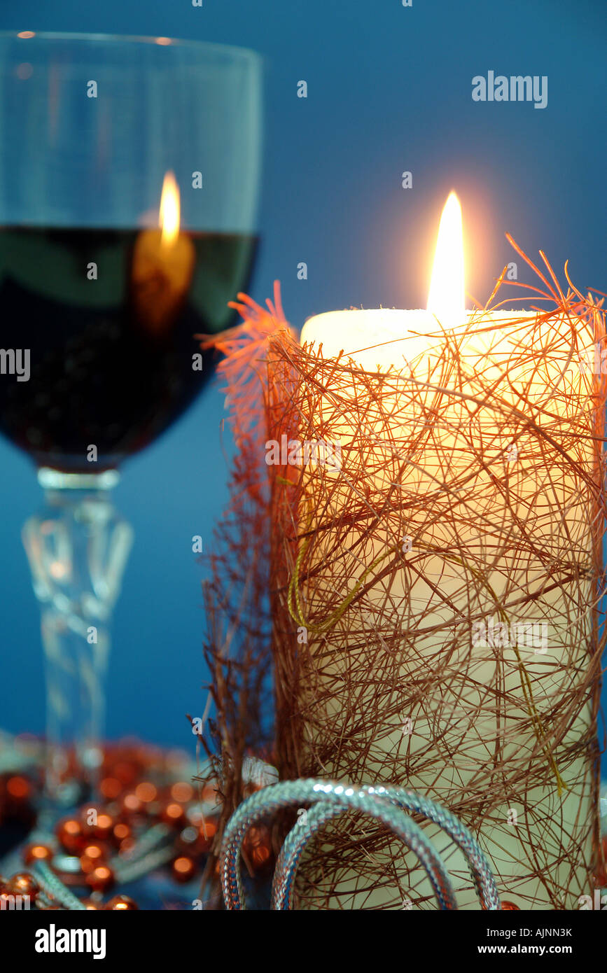 Glass of red wine with a candle in Christmas time Stock Photo
